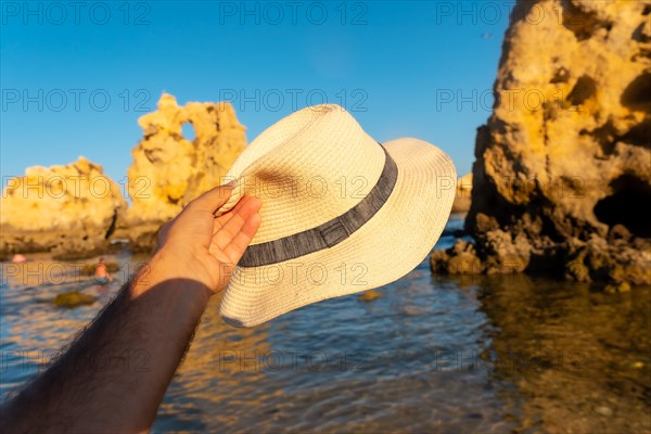 With a hat at Praia dos Arrifes