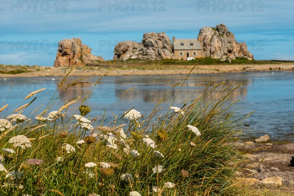 House between rocks next to a beautiful lake