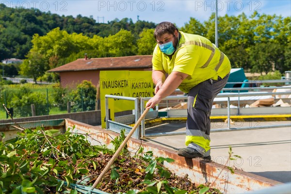 Worker in a recycling factory or clean point and garbage with a face mask and with security protections