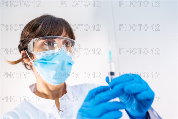 Female doctor with coronavirus vaccine injection. Antibodies