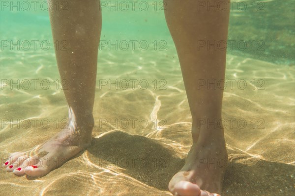 A young woman walking on a beautiful sandy seabed in the town of Zarautz very close to San Sebastian