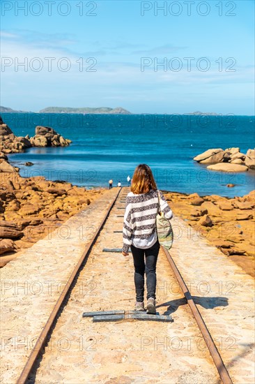 A young woman on the way to descend the boats next to the Mean Ruz Lighthouse