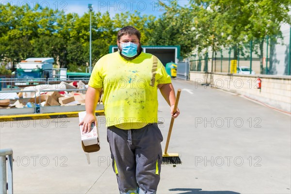 Worker in a recycling factory or clean point and garbage with a face mask and with security protections