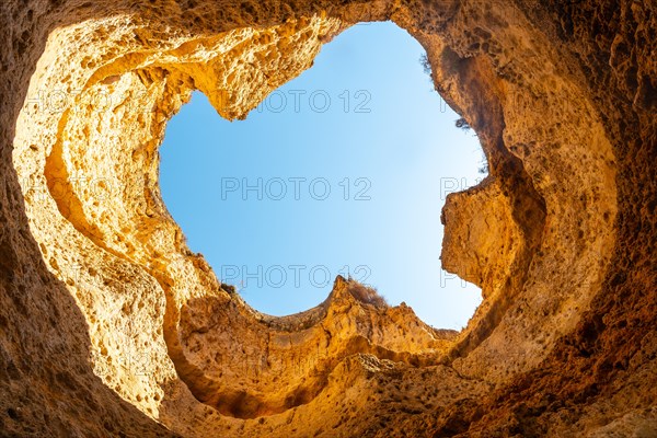 Natural arch or hole on the beach at Praia da Coelha