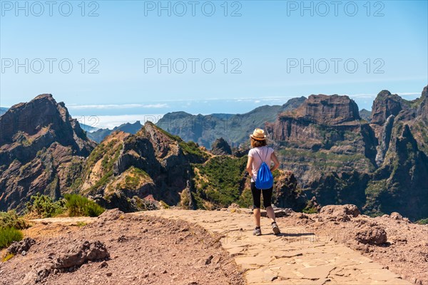 A tourist walking on the trekking trail at Pico do Arieiro