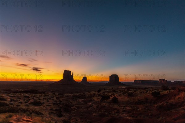 Panoramic of the first pink sunrise lights at Monument Valley in the beautiful August sunrise