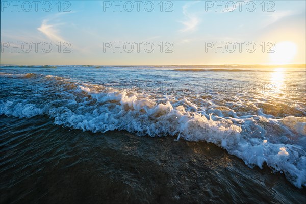 Atlantic ocean sunset with surging waves at Fonte da Telha beach