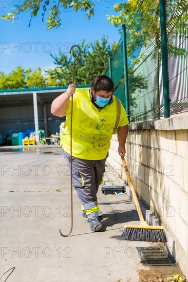 Worker in a recycling factory or clean point and garbage with a face mask and with security protections