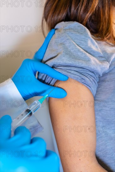 Female doctor giving the coronavirus vaccine to a young pregnant woman. Antibodies