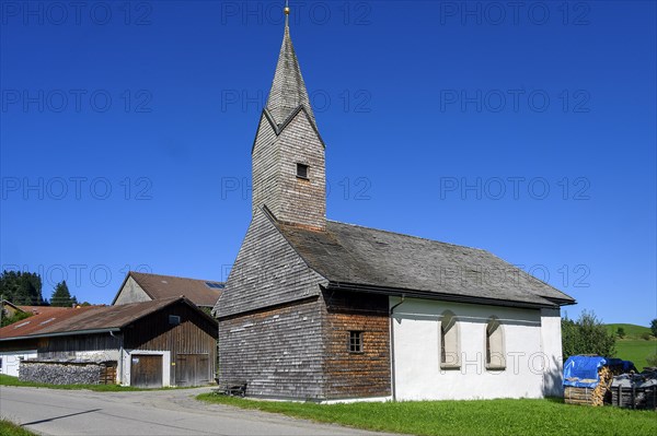 Chapel of St. Nicholas and St. Magdalena with many wooden shingles in Linsen near Niedersonthofen