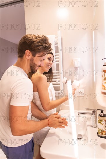 A newly awakened couple in pajamas preparing to go out in the toilet