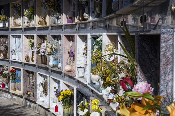 Wall with decorated urns graves in a cemetery in Sardinia