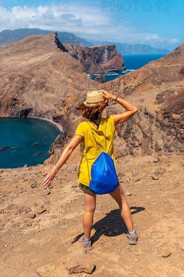 A young woman in Ponta de Sao Lourenco looking at the landscape and the sea