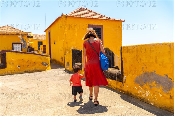 A mother walking with her baby inside the Forte de Sao Tiago in Funchal. Madeira