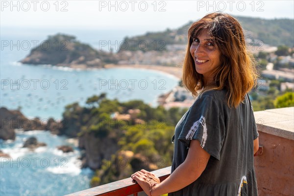 A young tourist looking at Tossa de Mar from the viewpoint