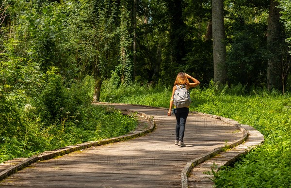 A young woman walking on the trek on the trail between La Garette and Coulon