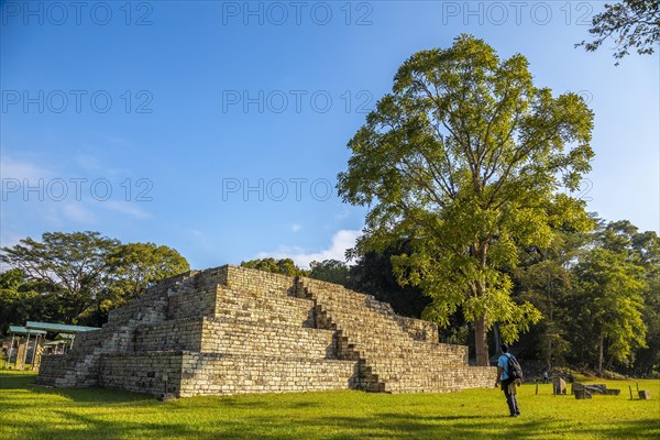 A young man watching A Mayan pyramid at The Copan Ruins temples. Honduras