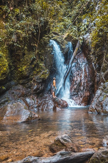 A young man in a waterfall of the Cerro Azul Meambar National Park