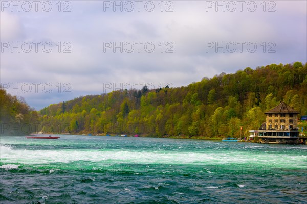 Rhine River and Swiss Flag with a Building at Neuhausen in Schaffhausen