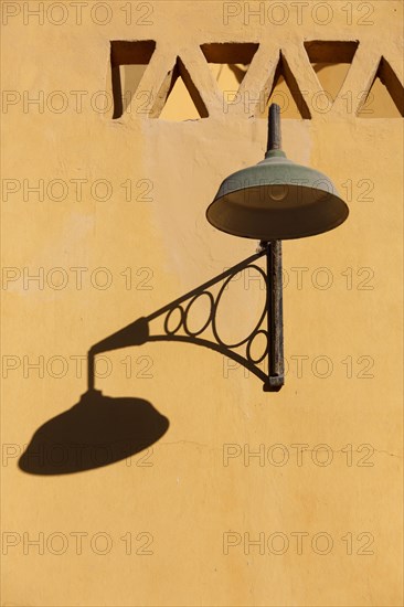 Lantern with shadow on a house wall