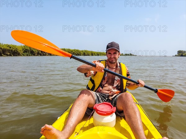 A young man in the canoe doing canoeing in the a natural park of Catalonia