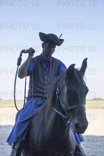 Cracking the whip with the Hungarian shepherd's whip on horseback