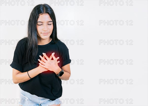 Young woman with tachycardia. Concept of people with heart problems. Latin woman with heart pain on isolated background