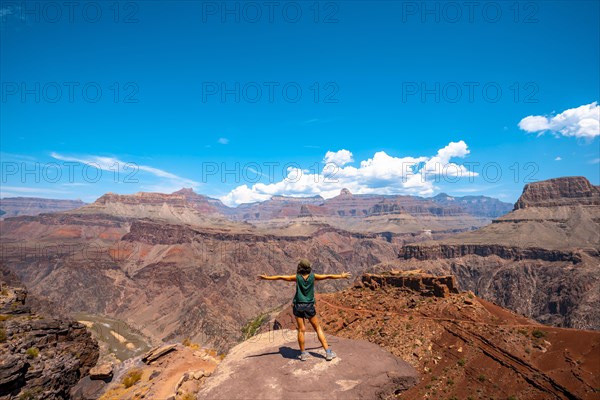 A young woman on a viewpoint of the South Kaibab Trailhead trekking. Grand Canyon