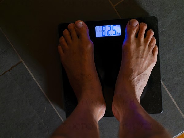 Men's feet on personal scale