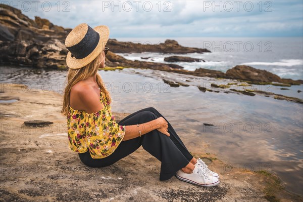 Caucasian blonde girl in a floral shirt