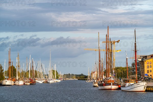 Sailing yachts and traditional sailing ships on the river Ryck in the harbour of Greifswald