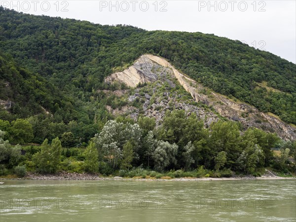 View over the Danube to a rocky slope and wooded area