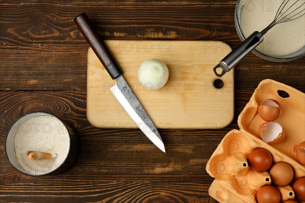 Top view of kitchen table with ingredients for omelette