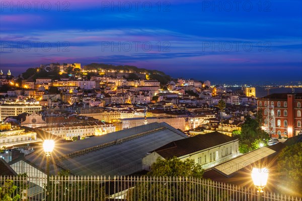 View of Lisbon famous view from Miradouro de Sao Pedro de Alcantara tourist viewpoint in the evening. Lisbon