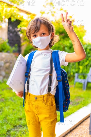 Caucasian child with face mask ready for back to school. New normality