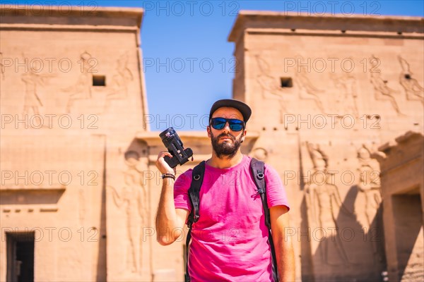 A young man in a pink shirt at the Temple of Philae