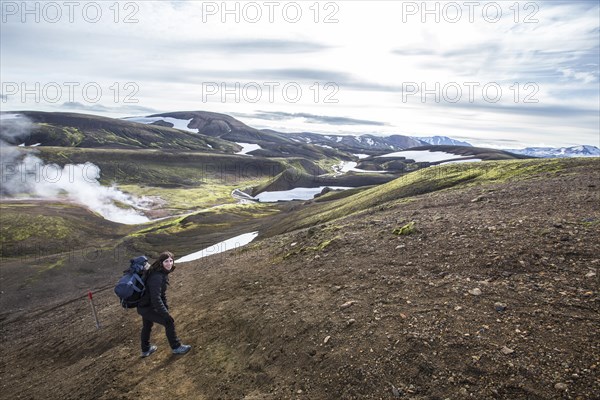 Woman in pools of boiling water on the 54 km trek from Landmannalaugar