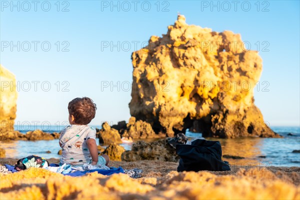 A baby on the beach in summer