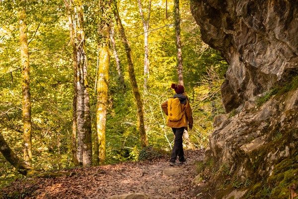 A young woman on the path to the Holtzarte suspension bridge