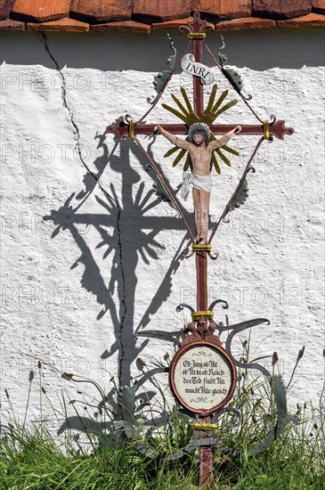 Cemetery wall with iron grave cross in the Swabian Open Air Museum