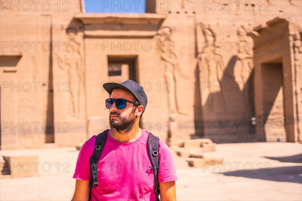 A young man in a pink shirt at the Temple of Philae