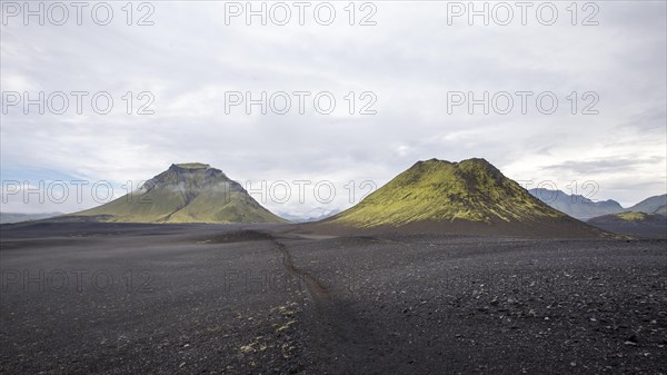 Volcanic ash and two green mountains in the background on the 54 km trek from Landmannalaugar