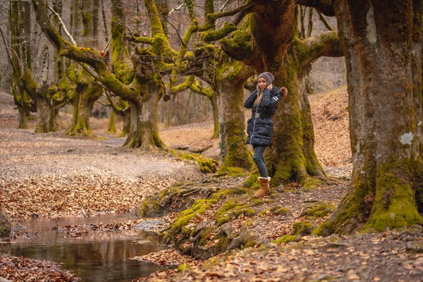 A young woman next to the Otzarreta Forest river in the Gorbea natural park