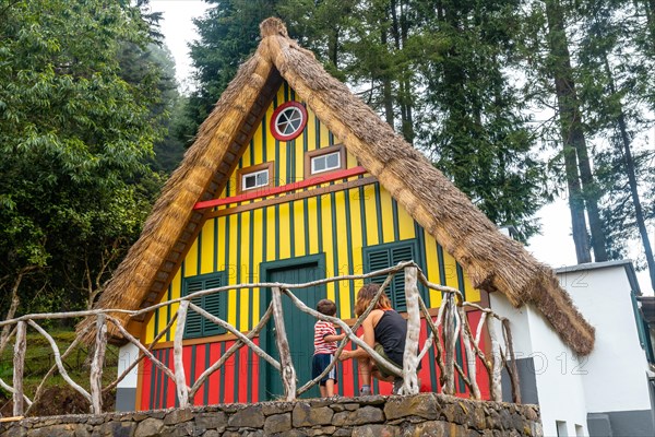 Mother and son in a Madeiran house like those of Santana in the forest of Caldeirao Verde