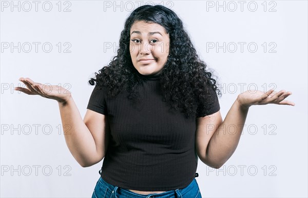 Puzzled woman raising hands isolated. Girl with a puzzled face raising her hands. Puzzled people making hand gestures