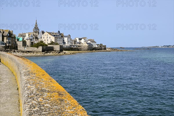 Old town with buildings and church tower by the sea