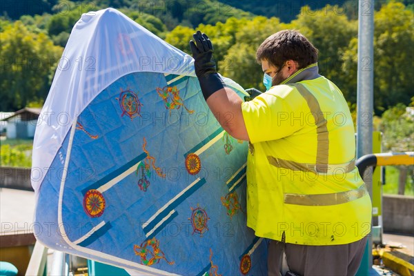 Worker in a recycling factory or clean point and garbage with a face mask and with security protections