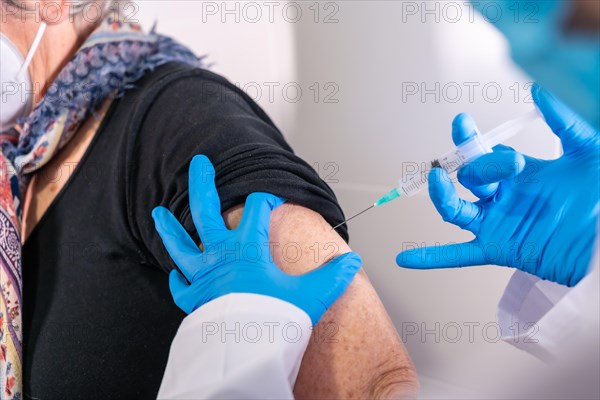 Injecting the coronavirus vaccine to an old lady