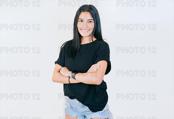 Portrait of beautiful latin girl with arms crossed. Smiling latin girl with arms crossed isolated. Nicaraguan woman on isolated background