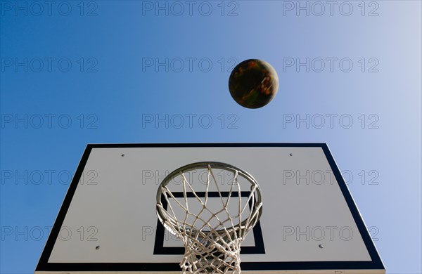 Basketball Hoop and a Ball Against Blue Clear Sky with Sunlight in Switzerland